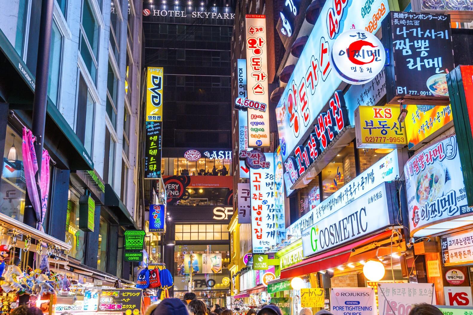 Neon signs on a busy street in Daegu